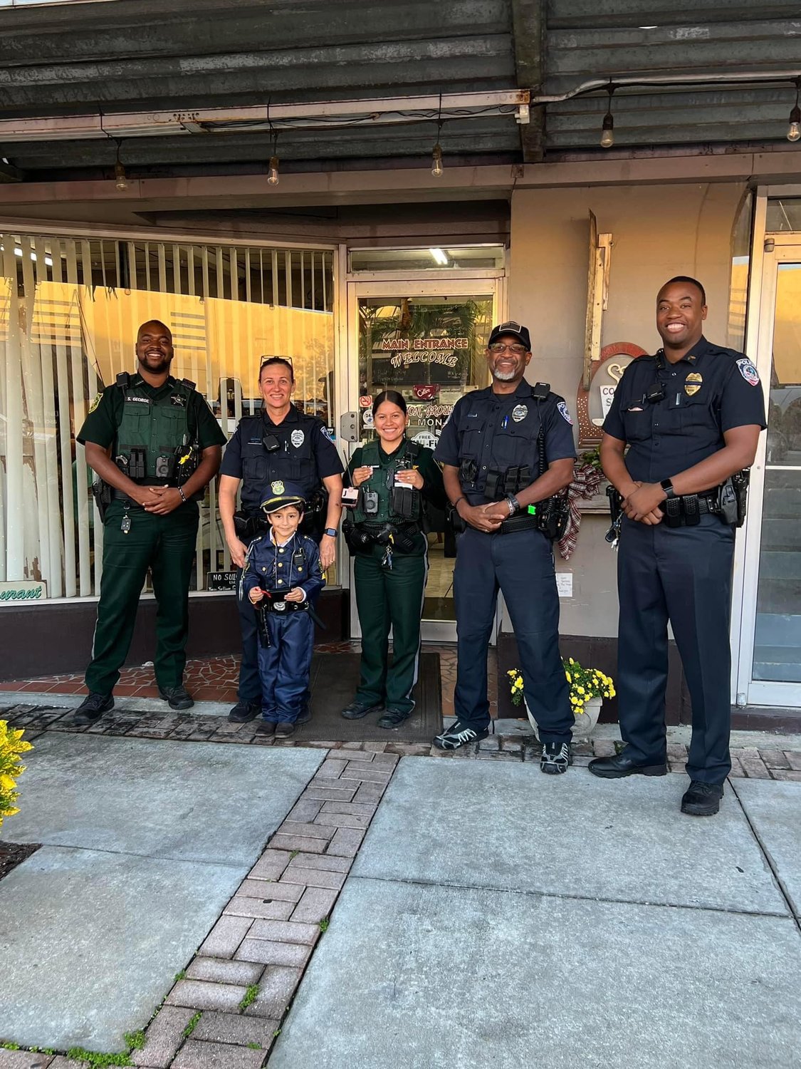 CLEWISTON  -- A Clewiston youngster asked for police to help him celebrate this birthday at Common Grounds Coffee Shop on Dec. 31 and Clewiston City Police officers were happy to make his birthday wish come true. [Courtesy photo]